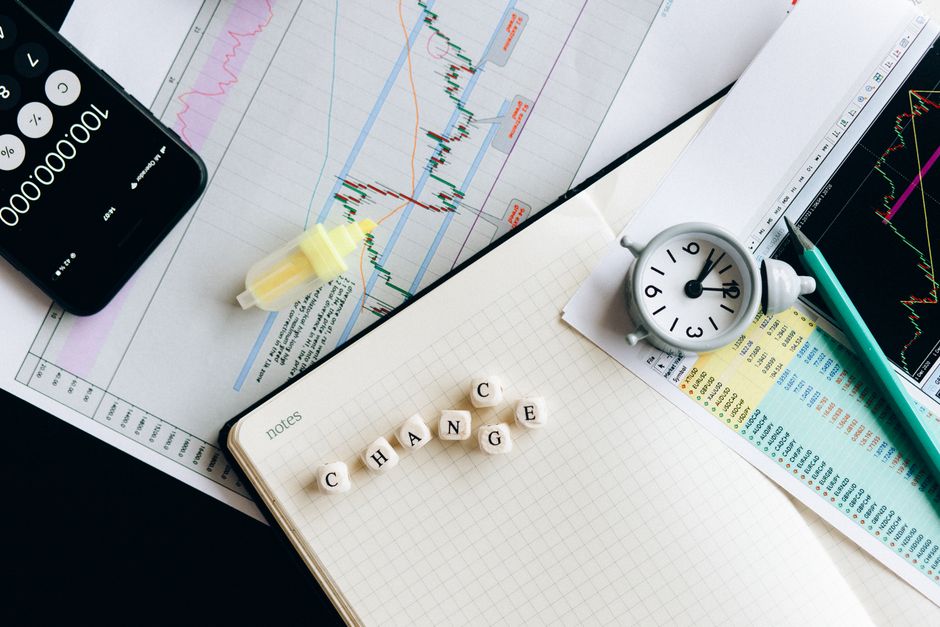 Top view of financial documents with charts, calculator, clock